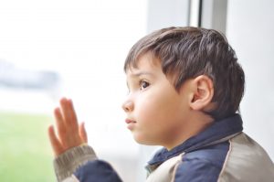 A kid on the window waiting