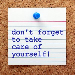 The words Don't Forget to Take Care of Yourself on a note card p